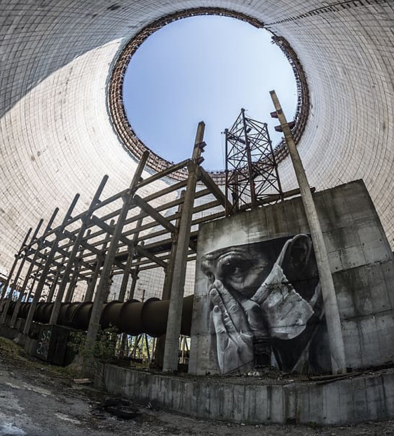 Chornobyl exclusion zone — cooling tower interior with face mural