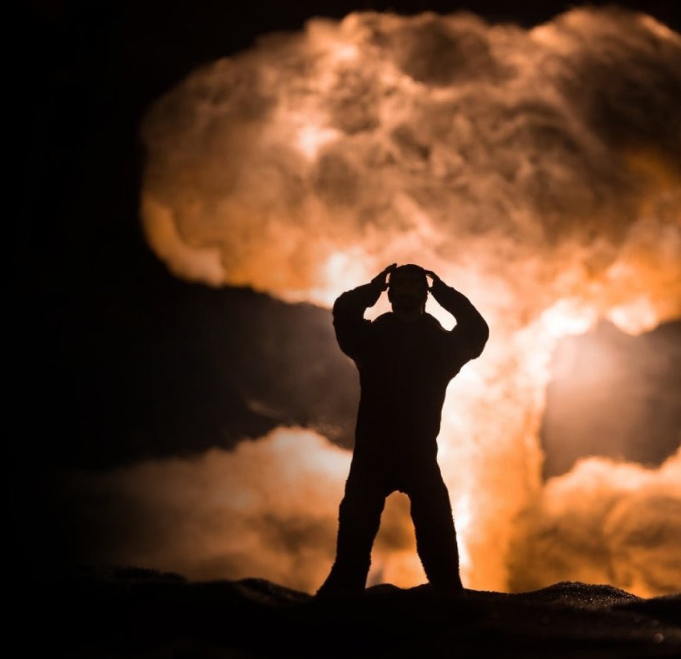 Figure silhouetted against a mushroom cloud — nuclear memory
